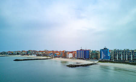 Panoramic bird's eye view over small ancient resort town of Pomorie with old European small houses and quiet calm empty streets, washed by the sea spring turquoise Black Sea on clear day in Bulgariaの写真素材
