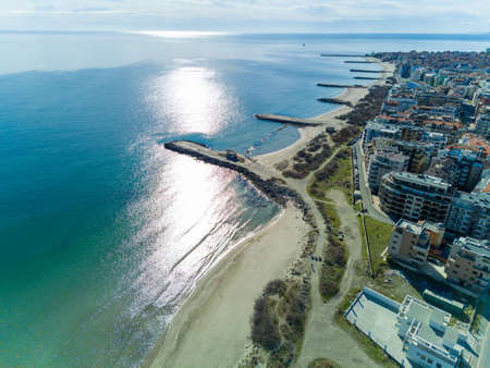 Panoramic view from a height above the town of Pomorie with houses and streets washed by the Black Sea in Bulgariaの写真素材