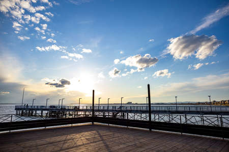 Side view of the pier on the Black Sea against the background of the sky and sunsetの写真素材