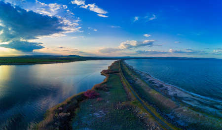 A bird's eye view panorama of a wild sandy dry grass shore washed by a deep calm evening Black sky in Bulgariaの写真素材