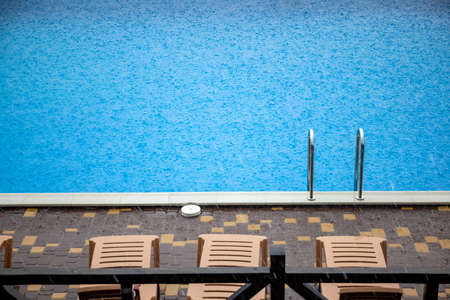 Incredibly heavy rain and fast, harsh wind spoil the warm, sunny summer weather at the tranquil base with pool for a long-awaited vacationの写真素材