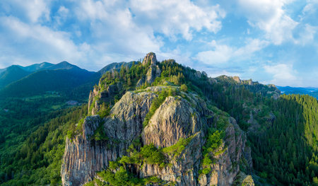 Peak of Rhodope mountain with forests against background of clouds. Panorama, top viewの写真素材