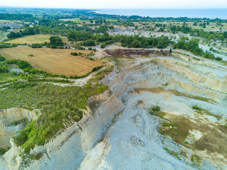 Sand craters in Montenegro and modern equipment and machines for the extraction of sand against the backdrop of mountainsの写真素材