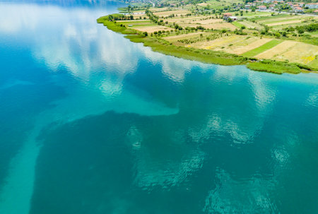 Fields planted with grain crops near Montenegrin villages on the coast of the Adriatic Sea against...