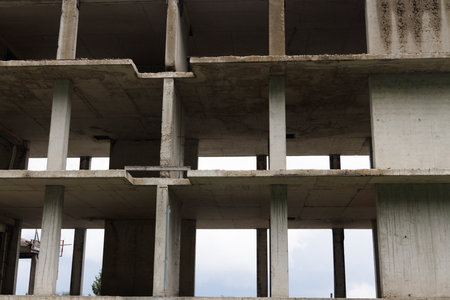 Abandoned unfinished building located along highway in forest wild valley of Rhodope Mountainsの写真素材