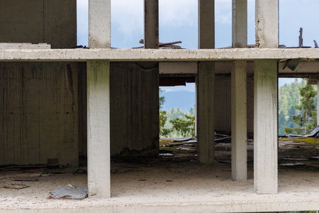 Abandoned unfinished building located along highway in forest wild valley of Rhodope Mountainsの写真素材