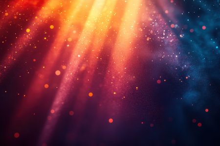 Radiant light beams cascade through a vibrant backdrop filled with sparkling particles and colors.の写真素材