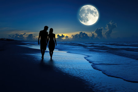 A couple strolls along a serene beach at night, illuminated by the full moon and gentle waves.の写真素材