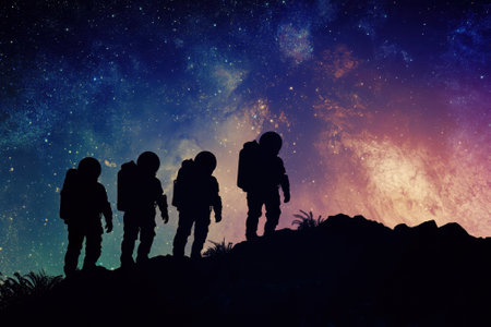 Four astronauts walk across a mysterious terrain while a vibrant galaxy fills the sky with colors.の写真素材