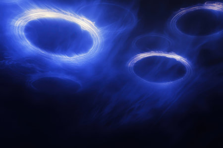 Bright blue rings light up the dark sky, creating an ethereal atmosphere during the night.の写真素材