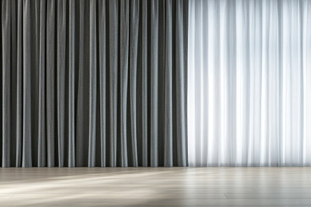 Soft light filters through sheer curtains, illuminating a minimalist space with textured drapes.の写真素材