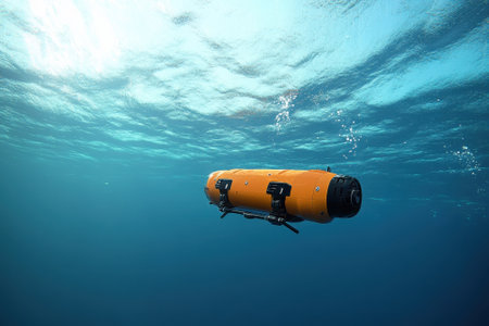 An underwater drone is navigating the ocean depths, capturing data and images in bright sunlight.の写真素材