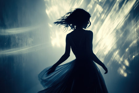A dancer gracefully twirls in a flowing skirt, enveloped in a soft, ethereal light, creating a magical atmosphere.の写真素材