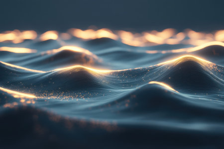 Waves gently ripple across the water, catching warm golden light at dusk near the coast.の写真素材