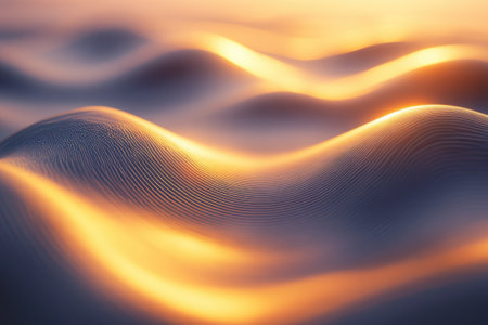 Soft, undulating waves reflect golden sunlight as day transitions to night, capturing serene beauty.の写真素材