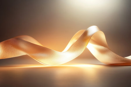 A shimmering ribbon gracefully curves under warm light, creating a soft and inviting ambiance.の写真素材