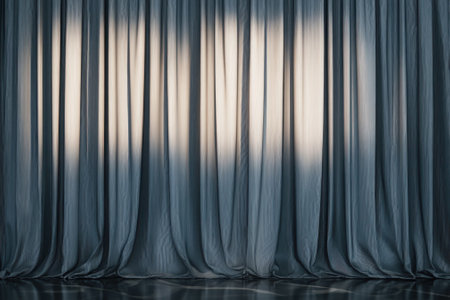 Soft blue curtains gently fall, diffusing natural light and creating a serene indoor atmosphere.の写真素材