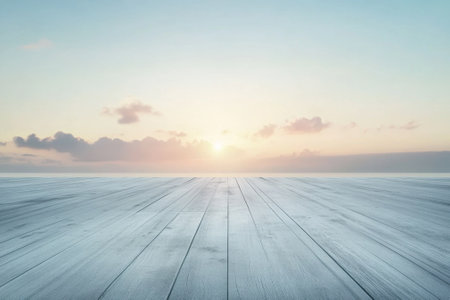 Wooden deck stretches out towards a stunning sunrise, casting soft hues in the early morning sky.の写真素材