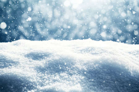 Soft snowflakes descend on a pristine layer of snow, creating a peaceful winter atmosphere outdoors.の写真素材