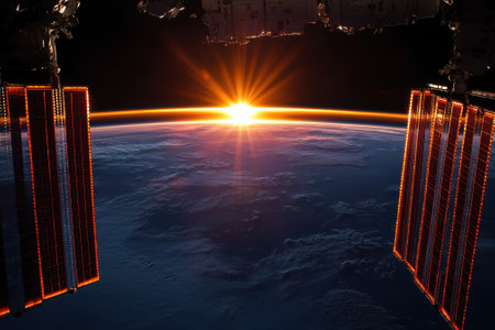 Sunrise illuminates Earth's atmosphere as seen from the International Space Station, showing vibrant colors.の写真素材