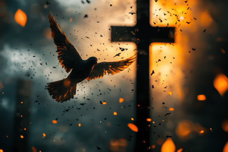 A bird flies gracefully near a cross surrounded by a vibrant sunset, with leaves gently falling around.の写真素材