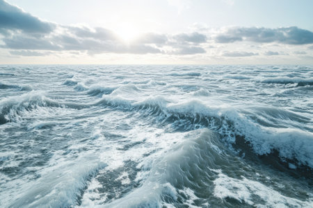 The powerful ocean waves roll and crash against each other as the sun sets, illuminating the sky with colors.の写真素材