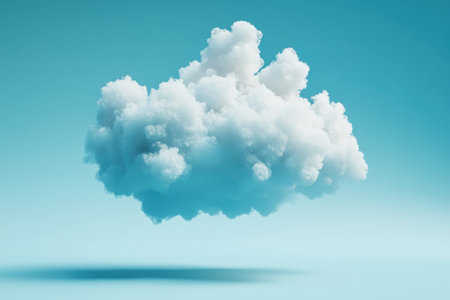 A fluffy white cloud drifts peacefully in a bright blue sky, showing the tranquility of nature.の写真素材