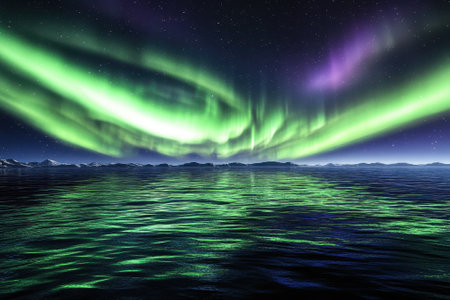 Bright northern lights dance across a tranquil lake, reflecting vivid colors in a remote wilderness at night.の写真素材