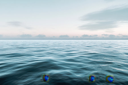 Tranquil sea surface reflects soft colors of dawn, creating a serene atmosphere before daybreak.の写真素材