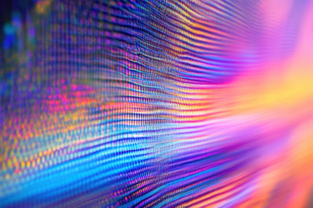 Colorful light patterns ripple dynamically across a digital surface, captivating viewers in the evening.の写真素材