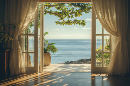 Large windows open to a breathtaking ocean view, inviting sunlight into the peaceful space.の写真素材