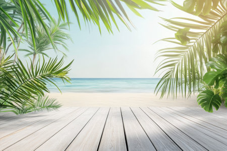 Tropical palm trees frame a tranquil beach scene with gentle waves lapping at the sandy shore under sunlight.の写真素材