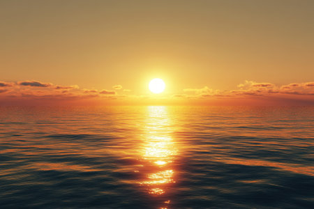 A stunning sunset casts warm colors over the ocean, with gentle waves reflecting its glow during dusk.の写真素材