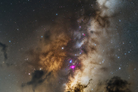 A stunning view of the night sky reveals countless stars and galaxies against a dark backdrop.の写真素材