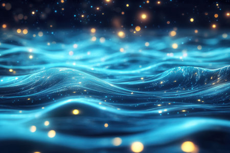 Waves gently undulate under a starry sky, with shimmering particles illuminating the serene ocean surface.の写真素材