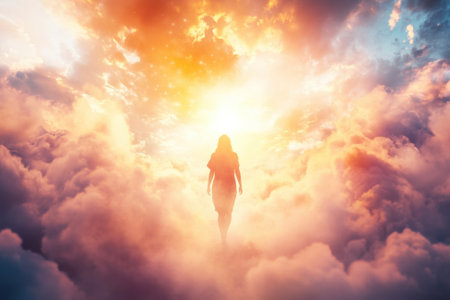 A figure walks purposefully toward a radiant light surrounded by colorful, swirling clouds during a mystical moment.の写真素材