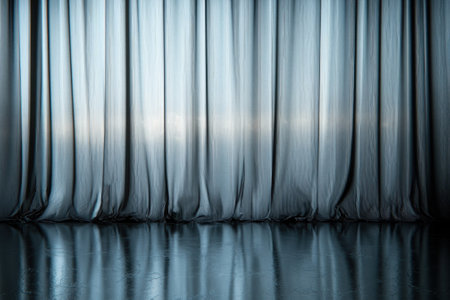 Soft blue curtains drape gracefully, reflecting light on a polished floor, adding tranquility to the room.の写真素材
