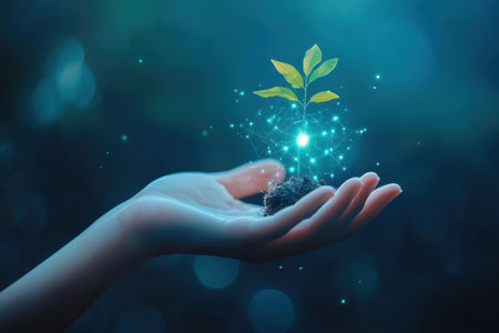 A hand cradles a young plant with glowing elements, highlighting themes of growth and environmental care.の写真素材