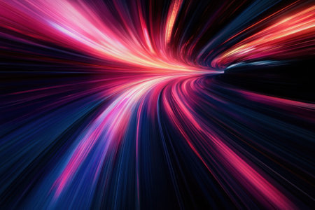 Bright and vivid light trails flow in a swirling pattern against a dark backdrop, creating a sense of speed.の写真素材