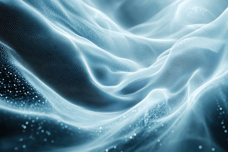 Blue fabric appears to flow softly, creating an ethereal atmosphere filled with light and texture.の写真素材