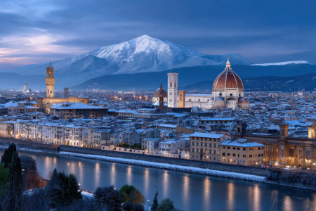 Florence glows under a dusk sky, showing historic buildings and snow-covered landscapes reflected in the river.の写真素材