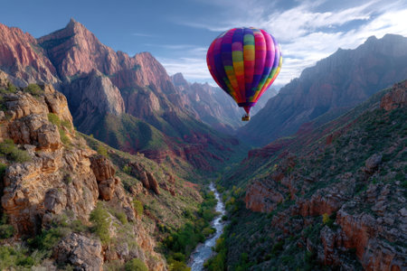 Colorful hot air balloon glides over Zion National Park's majestic canyons and rivers at sunset.の写真素材