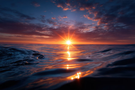 A breathtaking sunset paints the sky with vibrant hues while reflecting on tranquil ocean waters.の写真素材