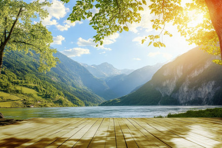 Sunlight shines on a serene lake surrounded by lush mountains and greenery, creating a peaceful vibe.の写真素材