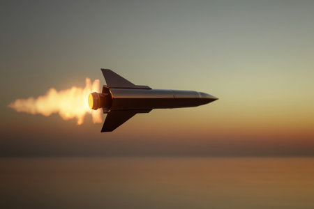 A rocket blasts off into the sky, leaving a trail of fire against a colorful sunset over the ocean.の写真素材