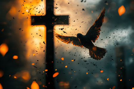 A bird flies gracefully near a cross surrounded by a vibrant sunset, with leaves gently falling around.の写真素材