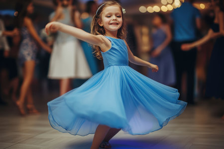 A girl spins in her beautiful blue dress, enjoying the dance floor filled with people in the evening.の写真素材
