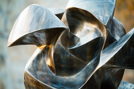 Curved metal forms intertwine brilliantly, showcasing the beauty of abstract design in a public space.の写真素材