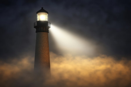 A tall lighthouse stands surrounded by dense fog, casting a bright light across the choppy waters at night.の写真素材