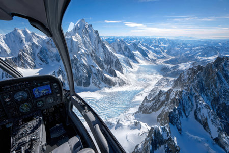 Aerial view of a snowy mountain range from a helicopter cockpitの写真素材